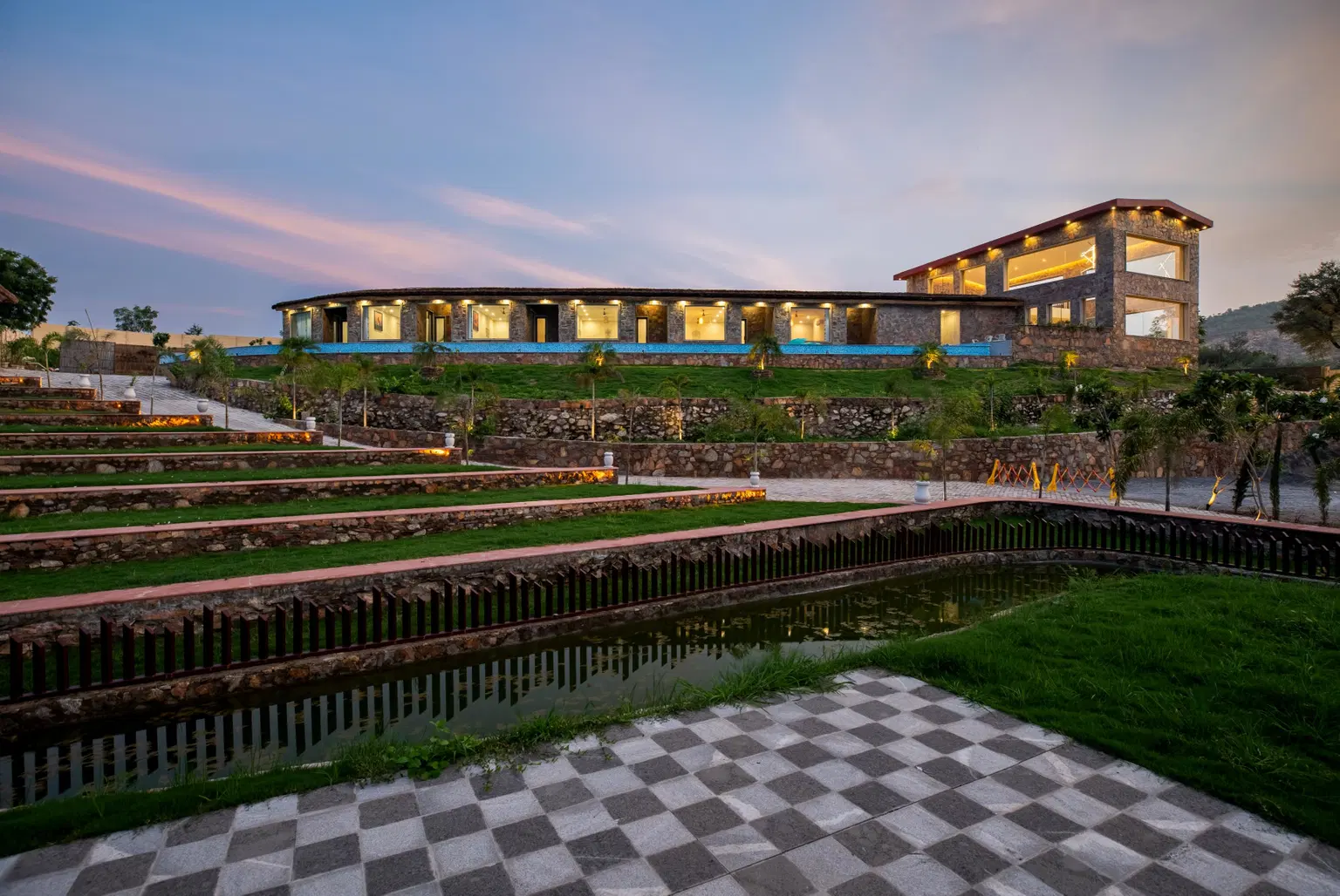 Luxury infinity pool at an Oru villa at dusk